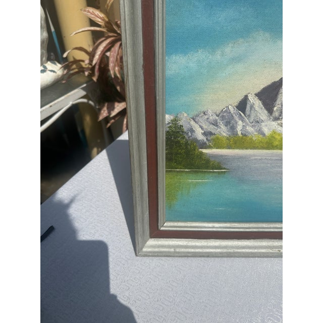 Up for consideration is a beautiful vintage framed waterside mountain landscape painting on canvas, signed by the artist....