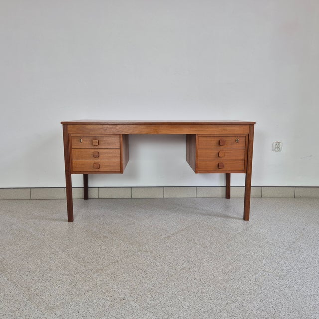 Danish Teak Desk by Domino Møbler, 1960s This elegant teak desk was produced in Denmark in the 1960s by Domino Møbler. A...