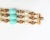 1960s goldtone resin faux-pearls and faux-turquoise speckled beads with fold over clasp. Marked "Napier." Measures: 8.25...