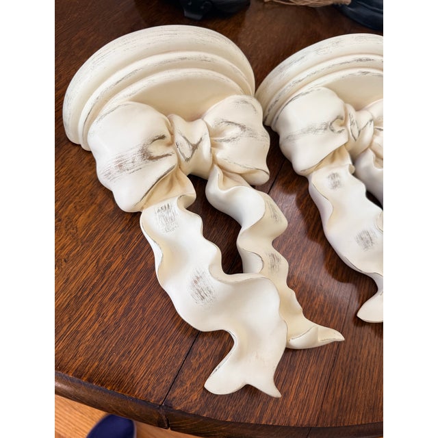 Designer Curated Vintage Hollywood Regency Distressed Cream & Gold Ribbon Bow Wall Shelves - Pair For Sale - Image 4 of 6