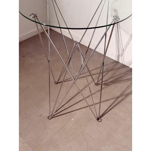 Elegant folding side table by Bjart , featuring a sculptural geometric base constructed from slender chrome-plated metal...