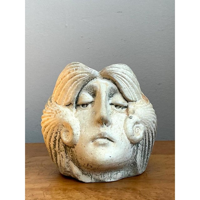 This vintage stoneware planter is carved in the form of a serene classical face, its profile rendered with soft,...