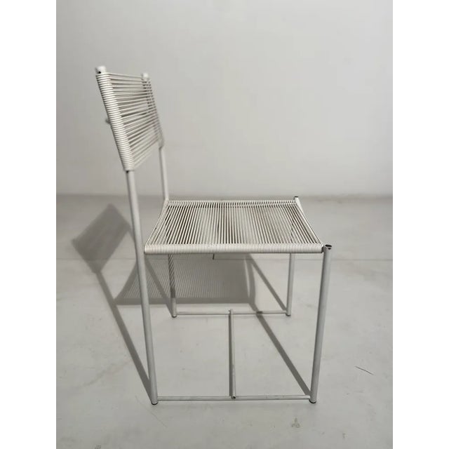 Chair with painted steel structure in the white color, seat and back are in white pvc rod. This piece has an attribution...