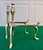 Antique pair of brass fire dogs (andirons). Ornate design, stylized floral/acanthus finials, and distinctively shaped...