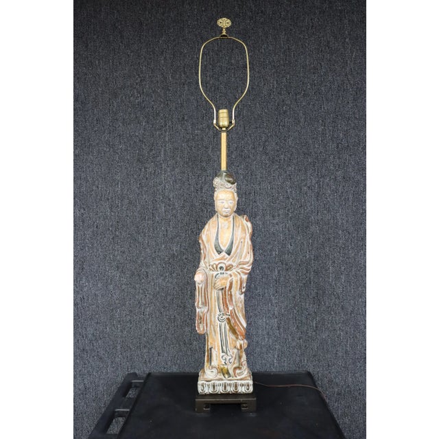 Chinese figural lamp , figure made of plaster , gold gilt finish with white and black highlights , black wood base