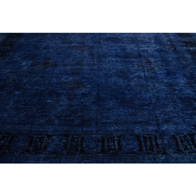Beautiful Transitional style hand-knotted wool rug with a navy blue field. This piece has dark accents, featuring a...
