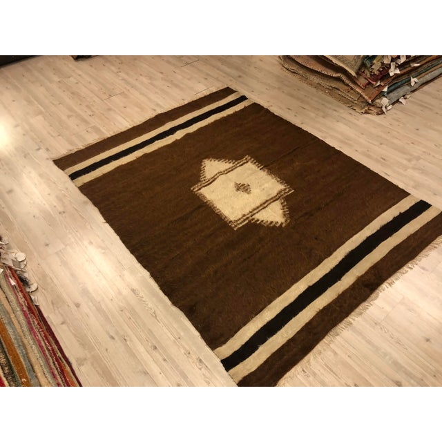 This is a Vintage Turkish Anatolian Kilim rug from the 1960s. The piece was hand-woven.