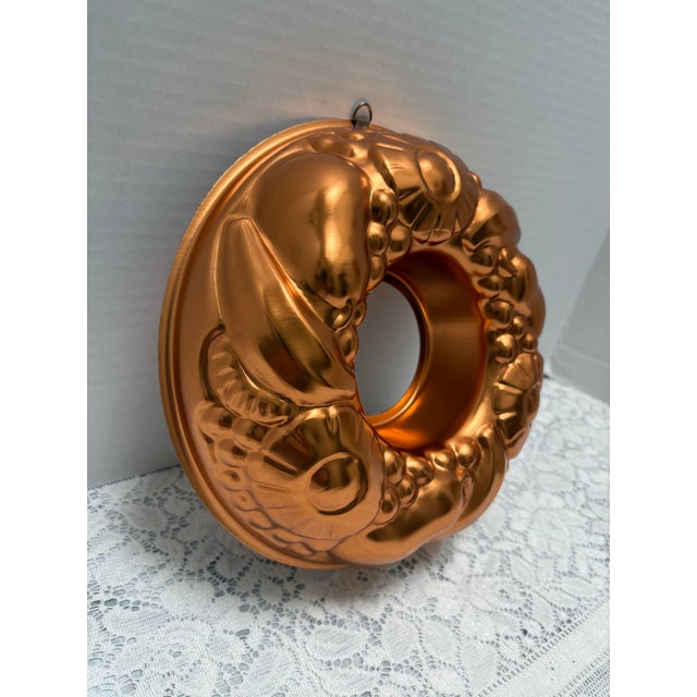 Vintage whimsical dirty patterned copper collared jello mold. Hook loop attached to hang as a wall accent in the kitchen....