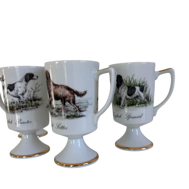 Set of 4: Mid-20th century beautiful porcelain hand-painted English hunting dog mug set. Showcases various breads of...