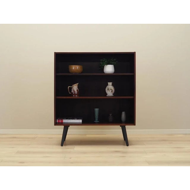 The bookcase was made in the 1970s, Danish production. The structure is covered with mahogany veneer. Legs made of solid...