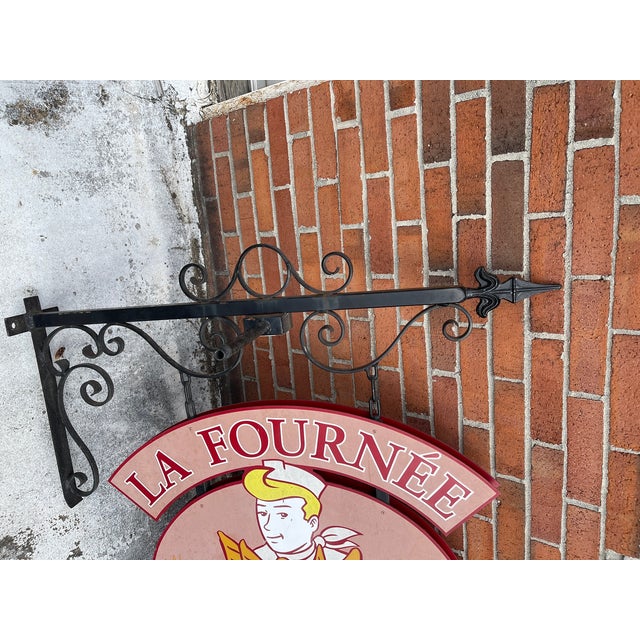 Hand painted French Country La Fournee du Boulanger (The Baker's Batch) iron double sided trade sign. The panels feature...