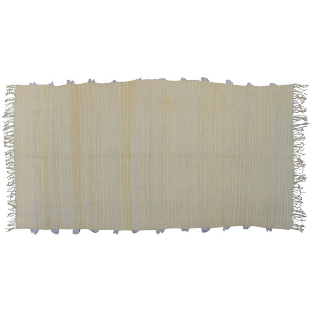 Vintage wedding blanket handmade in the High Atlas Mountains of Morocco. Featuring alternating stripes of wool fringe and...