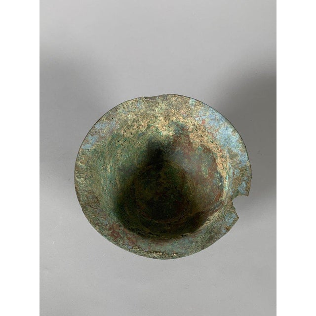 Archaic bronze vase on a pedestal from the Western Zhou Dynasty (1100-771 BC). The exterior walls are decorated with...