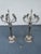 This elegant pair of silver-tone candelabras by Bombay Company showcases striking neoclassical design with eagle-head...
