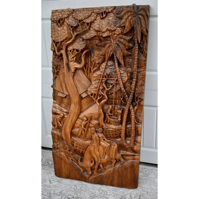 Vintage (1970's) Wall Plaque has a Tropical/Rustic Style. Made of Wood -Teak. Figural Details. The Measurements: 23"W x...