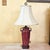 This refined vintage table lamp showcases a burgundy glazed ceramic urn-form body accented with sculptural side handles,...