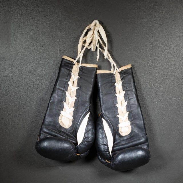 ABOUT Rare Ray Flores black leather boxing gloves with white leather thumbs. Original "Flores, San Francisco, CA" label...