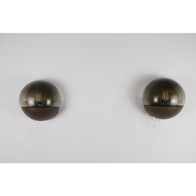 This atmospheric vintage pair features rounded black metal half-sphere bodies combined with smoked amber glass domes,...