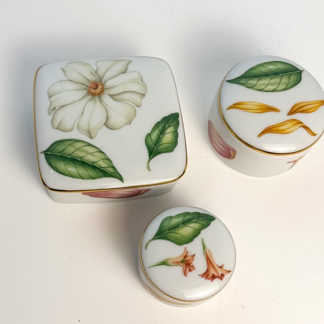 A coordinated set of three Tiffany & Co. “Tiffany Flowers” lidded trinket boxes in Limoges porcelain, made in France....