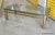 Vintage modern glass top living room coffee table. Tubular legs with flat bar supports with a rounded corner glass top. No...