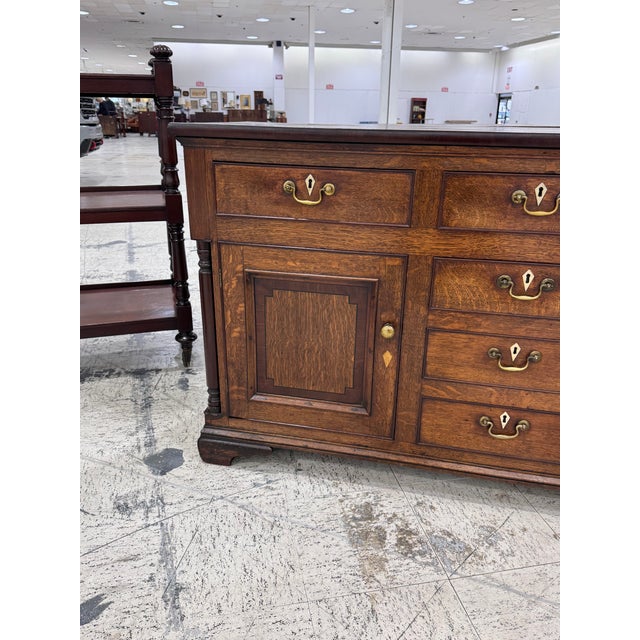 This is a Georgian oak dresser base or sideboard, likely dating to the 18th century or early 19th century. It features a...