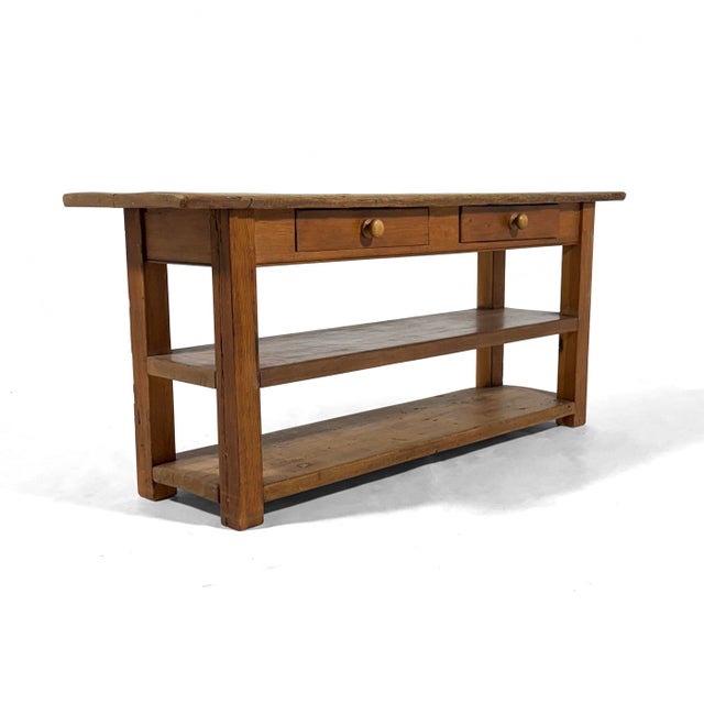 This antique farm table has character to spare. The substantial piece is crafted of solid wood, has two drawers and two...