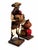 A characterful pair of vintage Mexican folk art market figures. The standing man wears a broad hat and carries a woven...