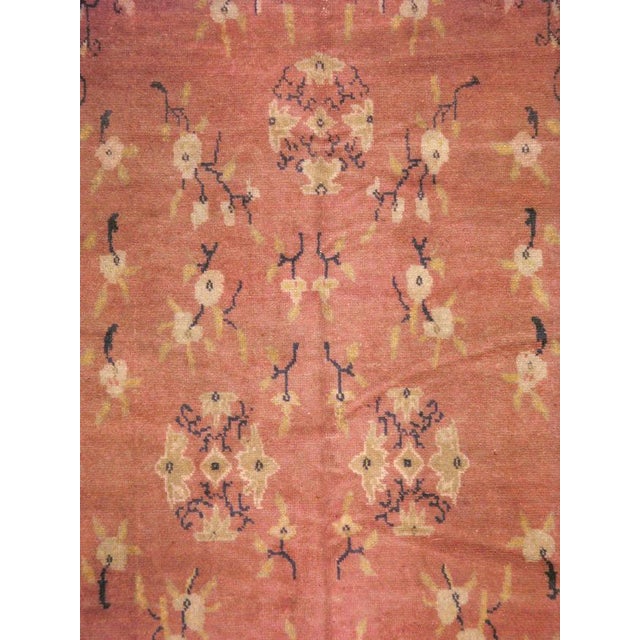 This mid-20th-century Turkish Anatolian accent rug presents a softly elegant floral composition centered on a warm coral...