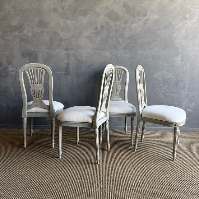 These beautifully aged antique European chairs feature their original painted finish, showcasing a soft, timeworn patina...