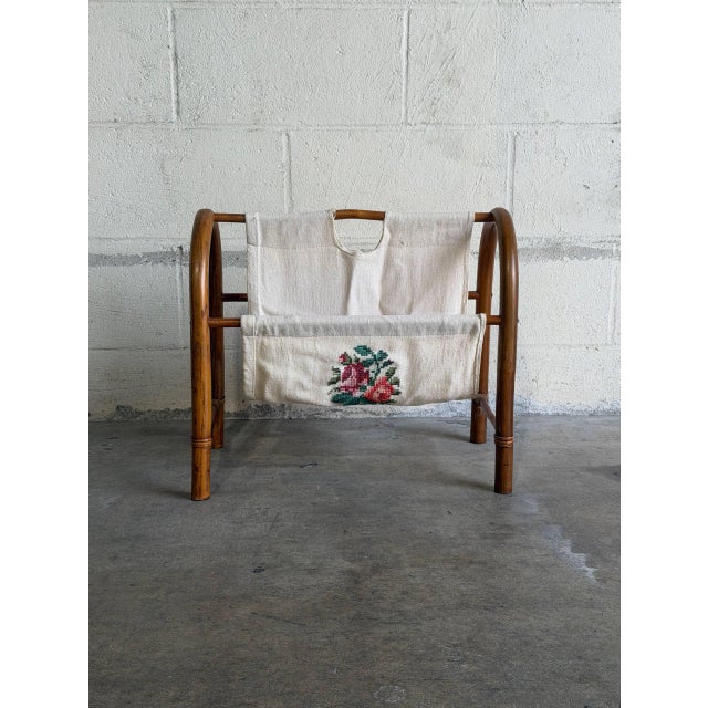 Smooth arched rattan frames support a double-pocket canvas sling featuring an embroidered flower motif. This charming...