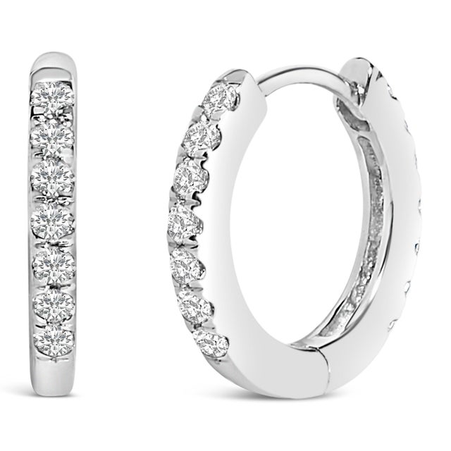 Discover pure elegance and refined allure with these 10K white gold huggie hoop earrings, a stunning testament to both...