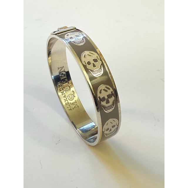 Iconic Alexander McQueen slip-on cuff. Featuring the fashion house's signature gothic-chic aesthetic, this piece showcases...