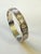 Iconic Alexander McQueen slip-on cuff. Featuring the fashion house's signature gothic-chic aesthetic, this piece showcases...
