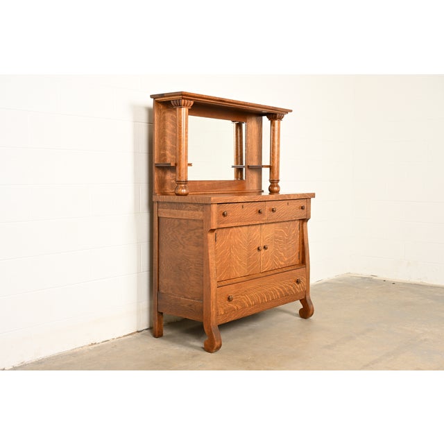 A gorgeous antique American Empire or Victorian style sideboard, credenza, buffet server, or bar cabinet In the manner of...