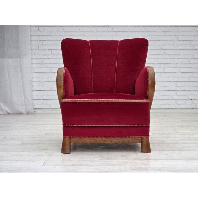 1960s, Danish armchair. Red furniture velour, oak wood, brass springs in the seat. Chair was reupholstered by craftsman...