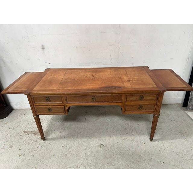 Louis xvi style desk in walnut and veneer four turned, fluted legs with bronze rings and sabots four drawers in the front...