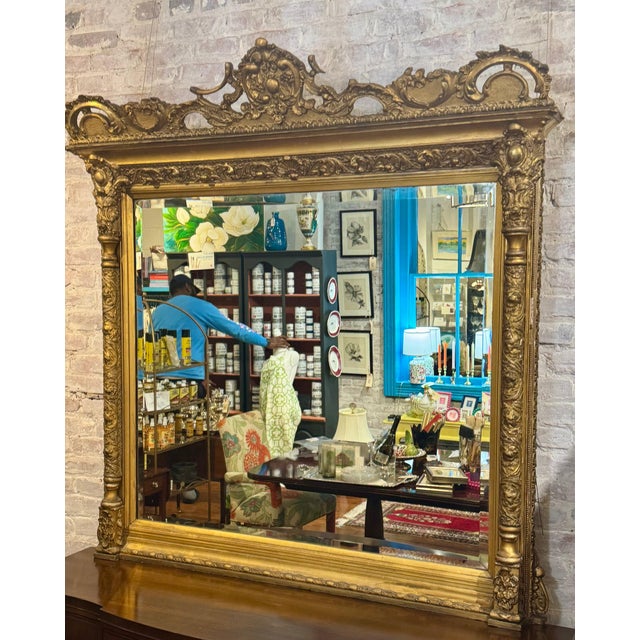 This 46.5 by 27-inch antique gilded mantel mirror combines artisanal craftsmanship with timeless elegance. Featuring a...