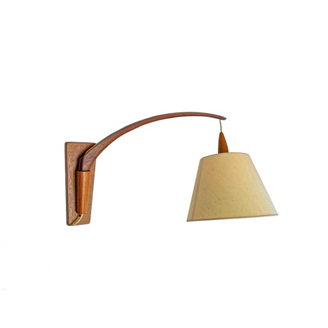 A large Scandinavian Design wall lamp made of Teak wood with the authentic fabric lampshade. Simple yet sophisticated and...