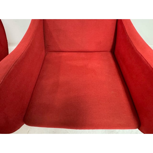 A striking pair of Italian armchairs dating to the 1960s, defined by their sculptural, enveloping form and bold use of...