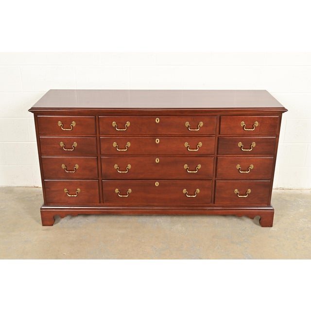A beautiful Georgian or Chippendale style twelve-drawer dresser, chest of drawers, or credenza In the manner of Henkel...
