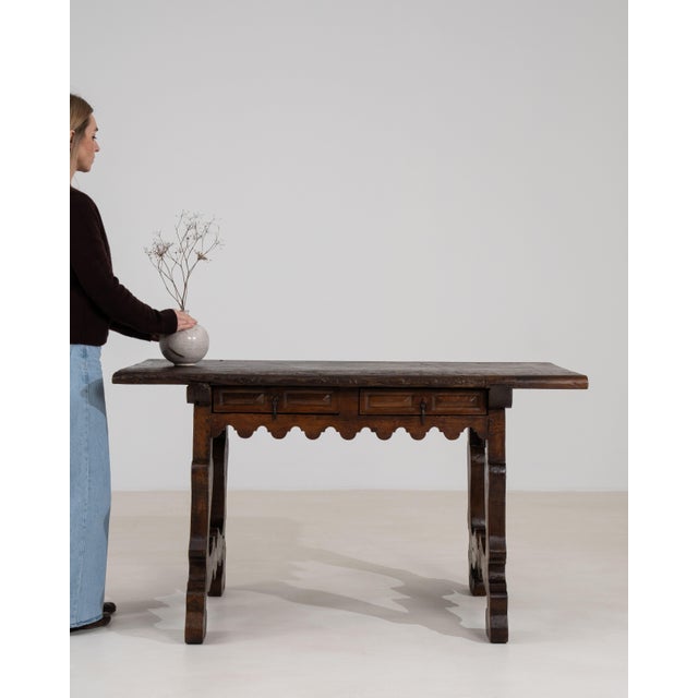 A rare Spanish Fratino table dating to around 1800, featuring a solid wood construction and distinctive trestle base with...