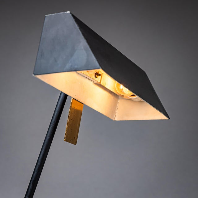 Table lamp in glass and brass by Fontana Arte, with side-mounted ashtray and black-lacquered lampshade. Illustrated in the...