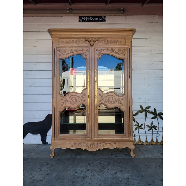 1970's vintage French style bleached Oak wood China cabinet. Beautiful carved designs. Two doors with wood and glass, four...