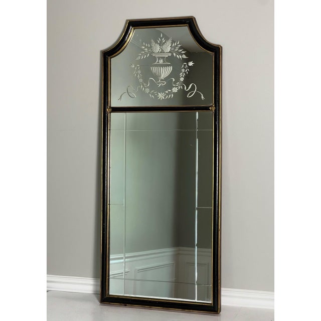 Tall and narrow Queen Anne style mirror with etched decoration and beveled glass in an ebonized and parcel giltwood frame...