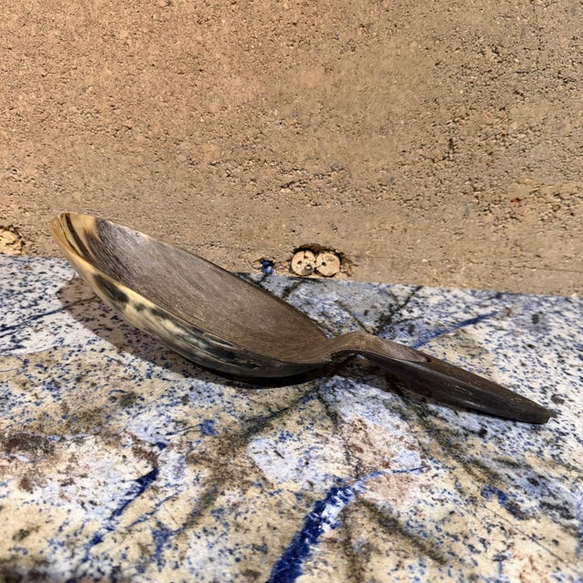 For your consideration, a handcrafted spoon or ladle made from natural animal horn, such as cow or buffalo horn....