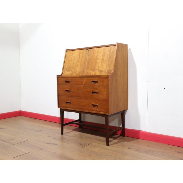 This Mid Century Modern Vintage Teak Secretaire Bureau Desk in Danish style is a stunning secretaire that embodies great...