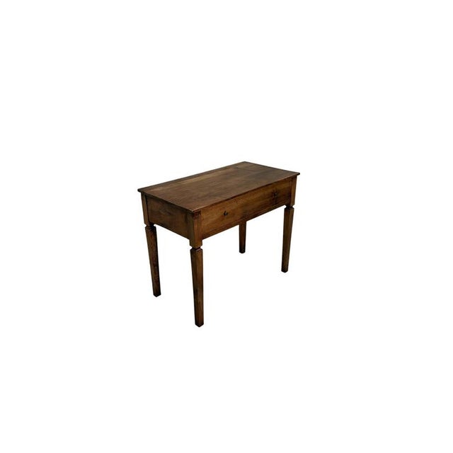 An elegant 18th-century writing desk crafted from fine walnut, this piece features a harmonious structure and refined...