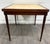 This is a vintage mahogany folding card table or game table featuring a warm mahogany finish, turned legs, and original...