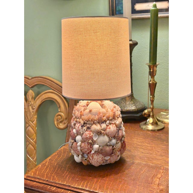 This petite lamp has a lot going on for a small piece. The body is encrusted sailor valentine style with an assortment of...