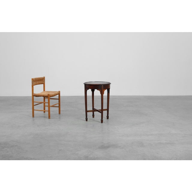 This 19th‑century French round side table embodies the understated charm and practical elegance of rural craftsmanship....